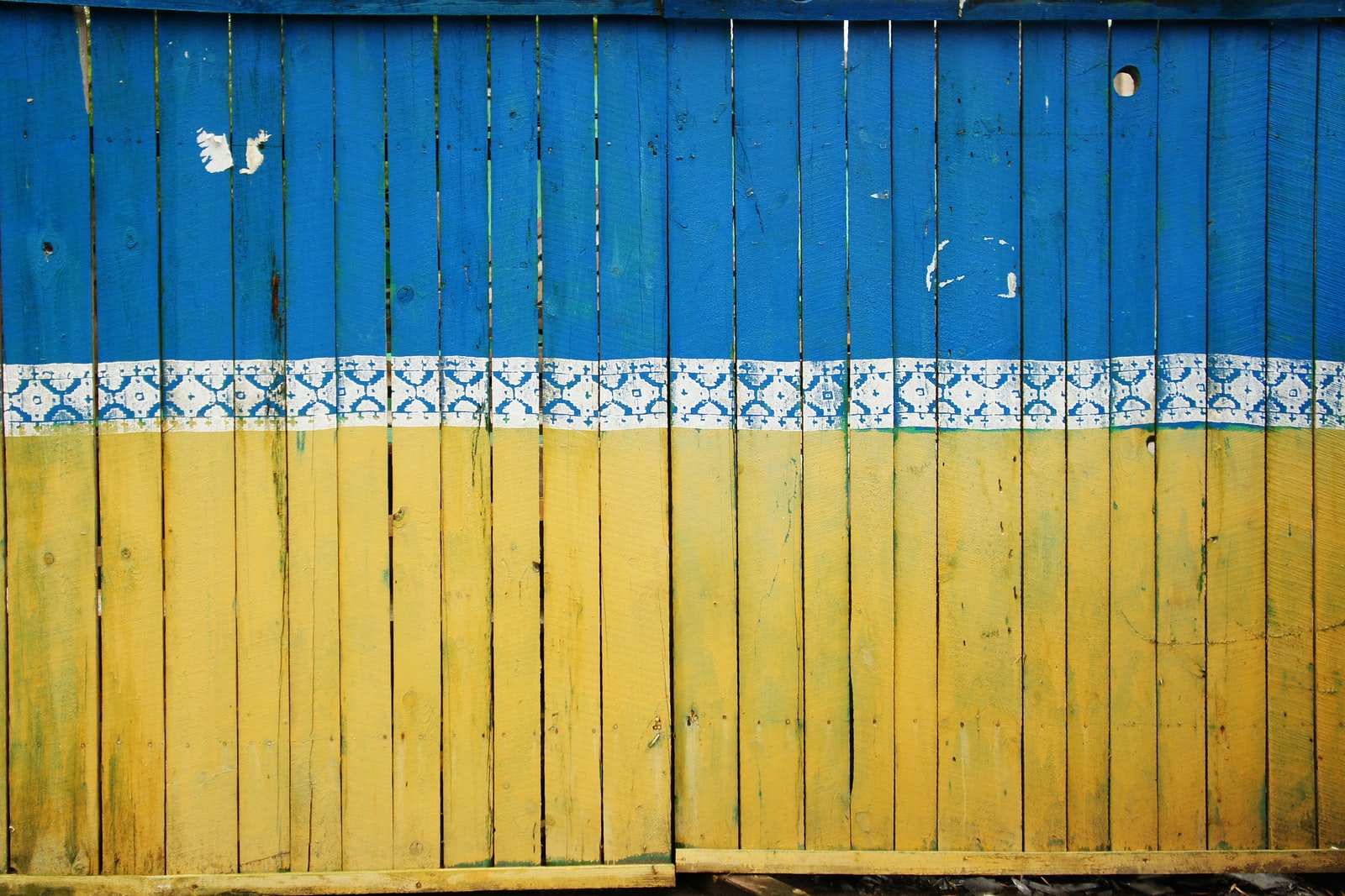 yellow and blue wooden fence